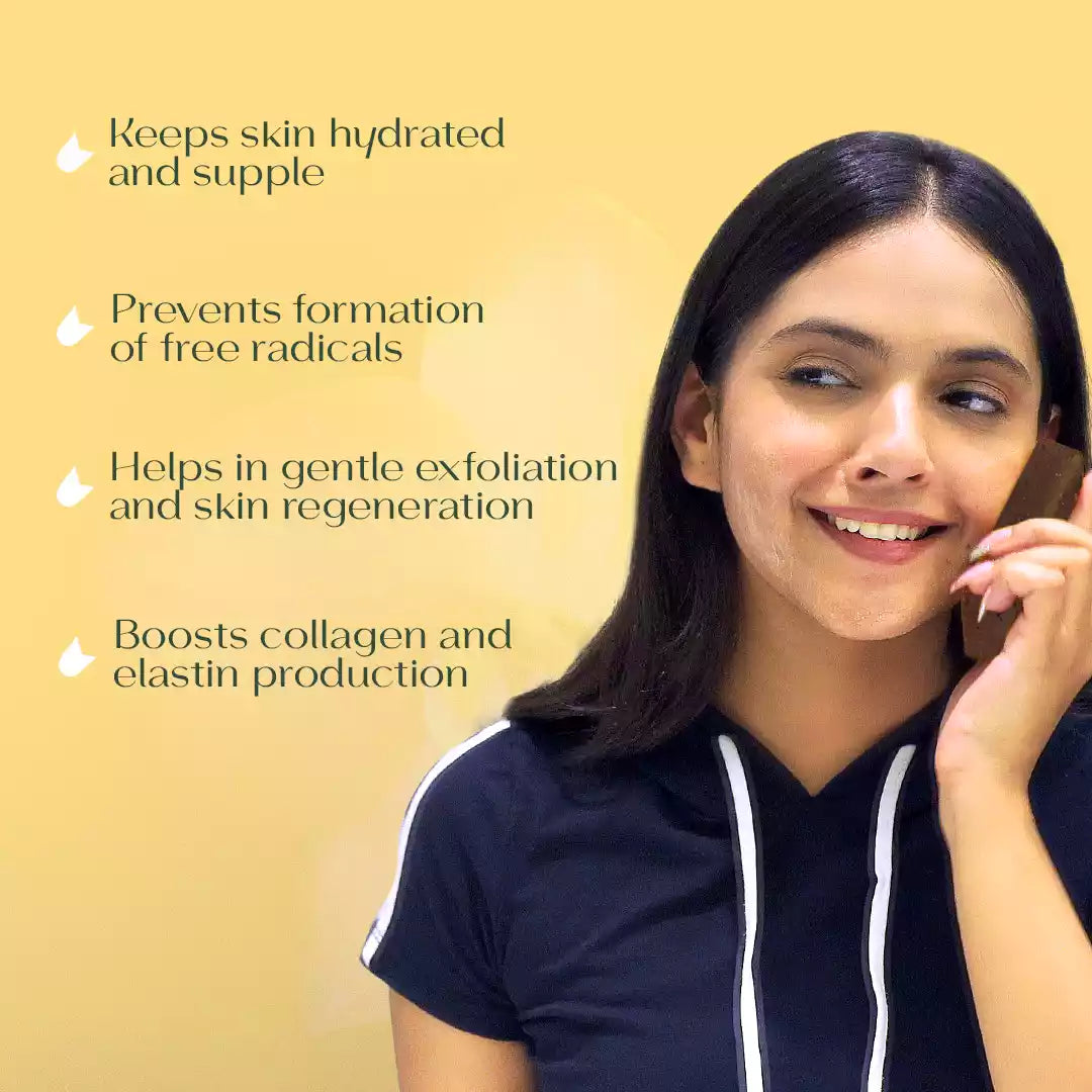 Woman holding Darzata almond soap on her cheek highlighting its benefits