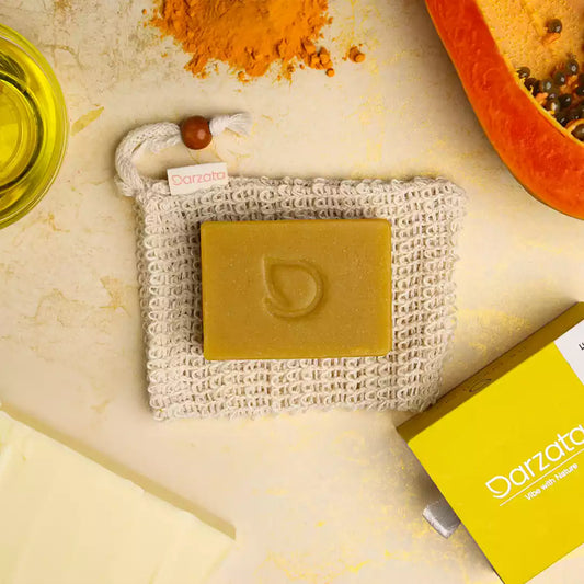 top view of turmeric papaya soap with darzata packaging and natural ingredients