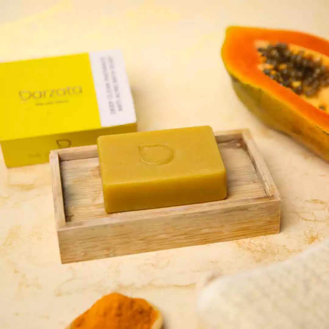 side view of turmeric papaya soap with darzata packaging and natural ingredients